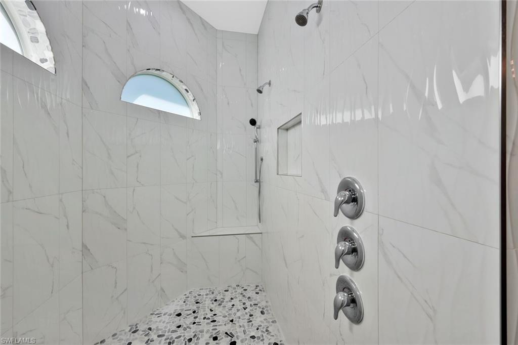 589 12th Avenue Northwest Naples, FL 34120 - Photo 11 of 28 a bathroom with a shower