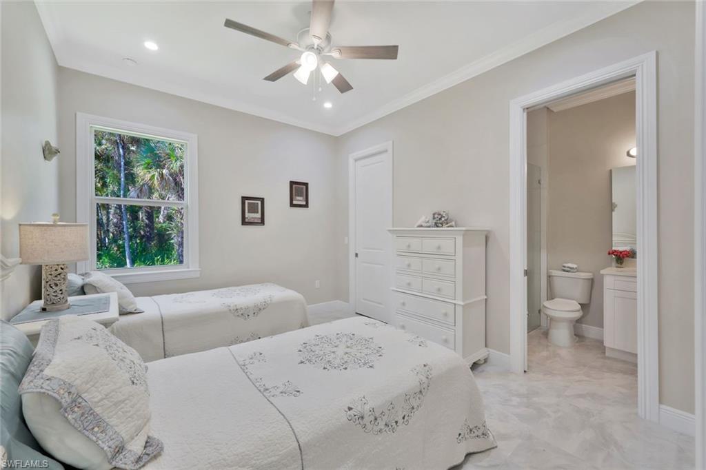 589 12th Avenue Northwest Naples, FL 34120 - Photo 15 of 28 a spacious bedroom with a bed and a view of bathroom
