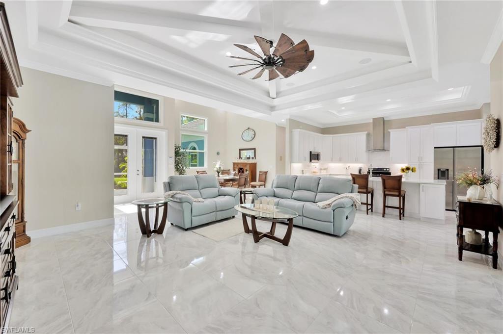 589 12th Avenue Northwest Naples, FL 34120 - Photo 2 of 28 a living room with furniture and a large window