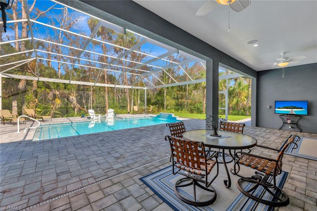 589 12th Avenue Northwest Naples, FL 34120 - Photo 21 of 28 a dining room with furniture and a floor to ceiling window