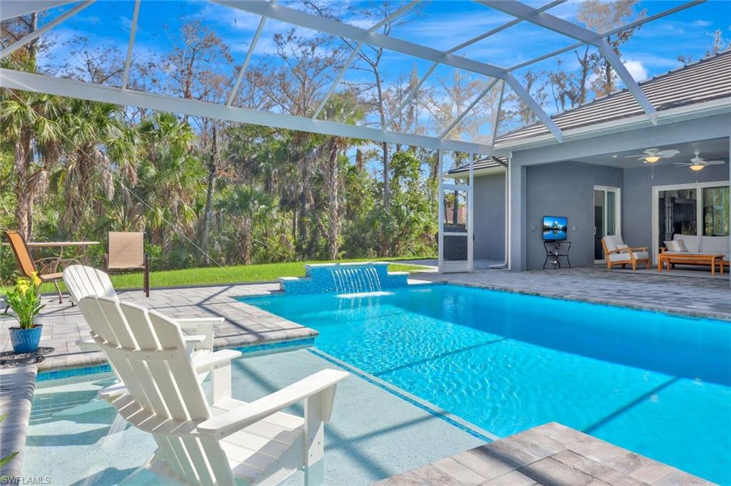589 12th Avenue Northwest Naples, FL 34120 - Photo 23 of 28 a view of a patio with a table and chairs under an umbrella