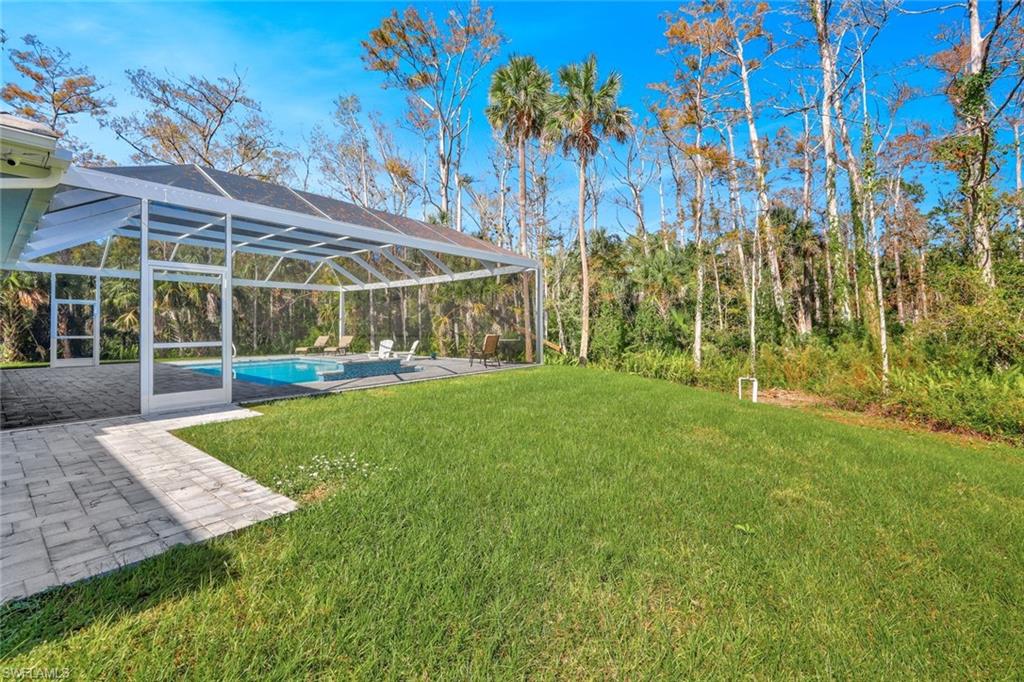 589 12th Avenue Northwest Naples, FL 34120 - Photo 27 of 28 a view of a big yard with plants and large trees