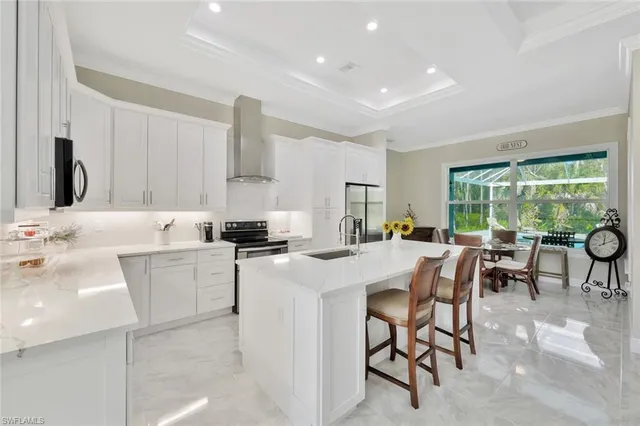 a kitchen with a table chairs and a refrigerator
