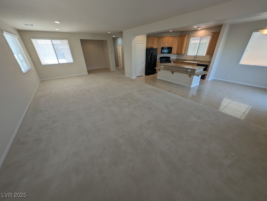 62 Augusta Course Avenue Las Vegas, NV 89148 - Photo 25 of 26 Kitchen with open floor plan, a kitchen bar, a center island, plenty of natural light, and recessed lighting