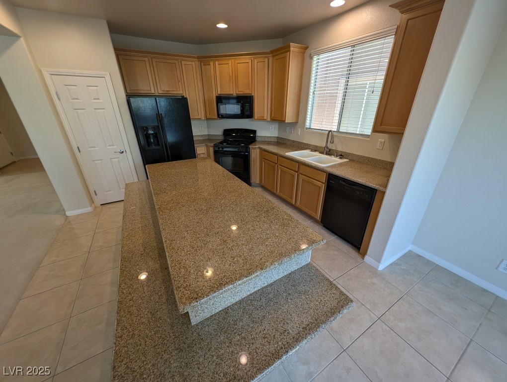 62 Augusta Course Avenue Las Vegas, NV 89148 - Photo 5 of 26 Kitchen with black appliances, recessed lighting, light tile patterned flooring, light stone countertops, and a center island