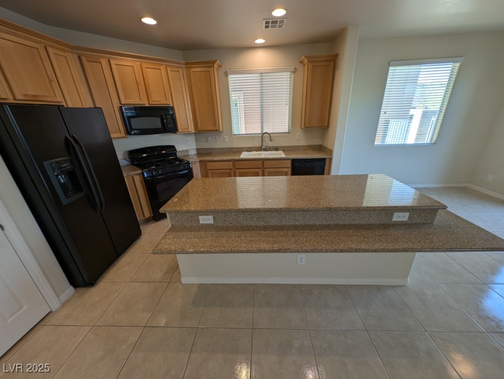 62 Augusta Course Avenue Las Vegas, NV 89148 - Photo 6 of 26 Kitchen featuring black appliances, light tile patterned floors, plenty of natural light, recessed lighting, and a kitchen island