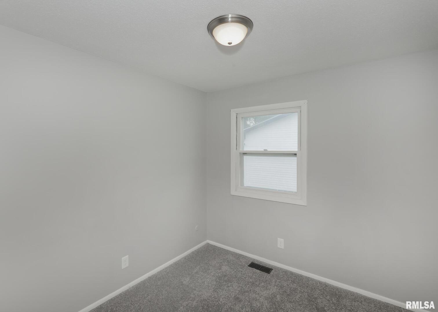 1310 Calvin Street Davenport, IA 52804 - Photo 23 of 39 an empty room with a window