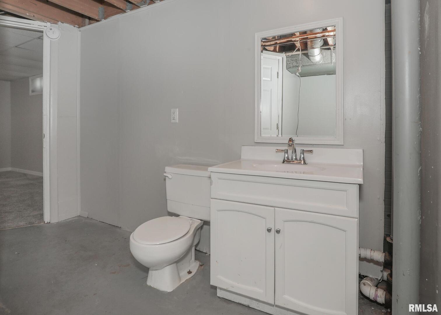 1310 Calvin Street Davenport, IA 52804 - Photo 36 of 39 a bathroom with a sink toilet and a mirror
