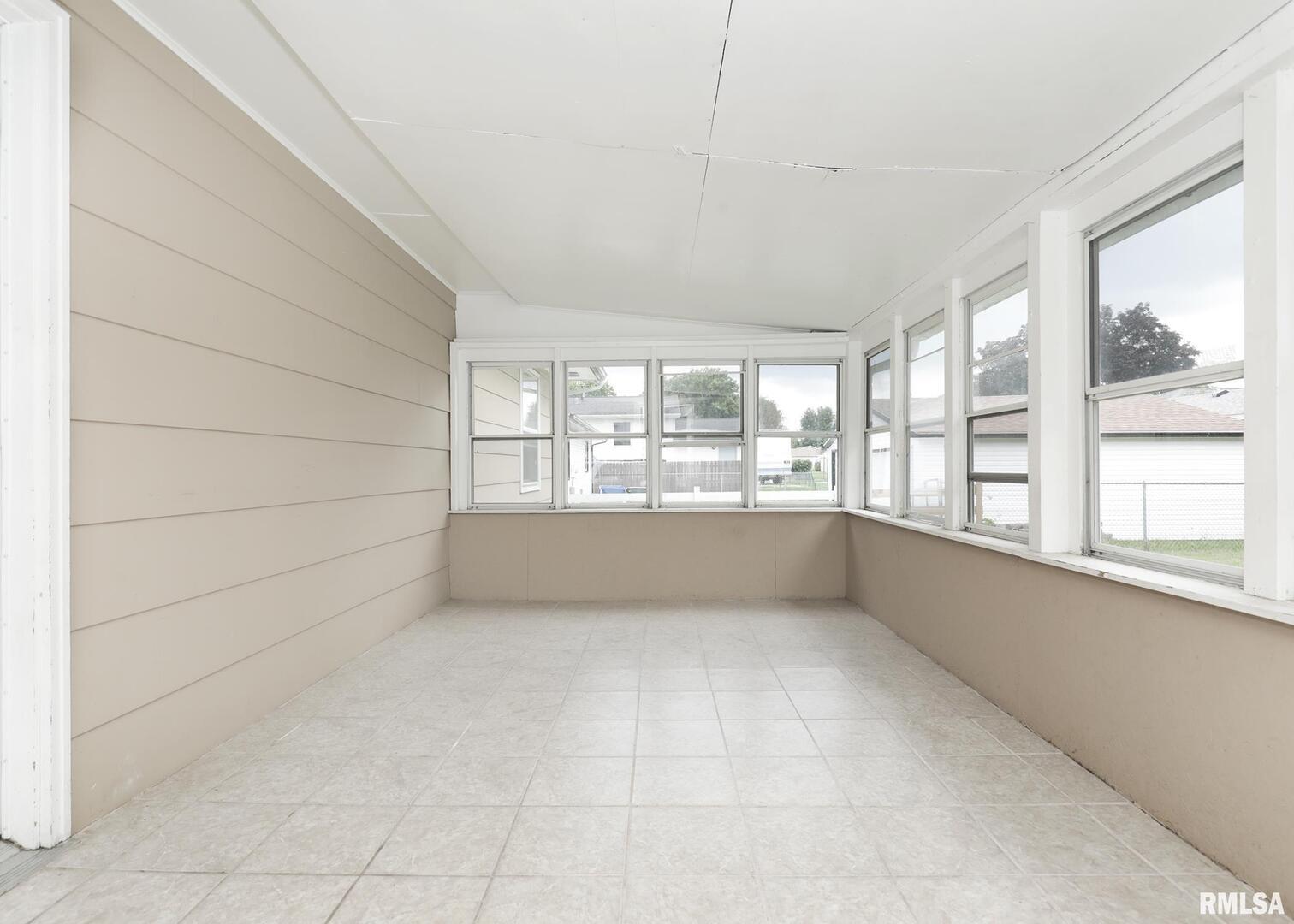 1310 Calvin Street Davenport, IA 52804 - Photo 5 of 39 a view of an empty room with a window