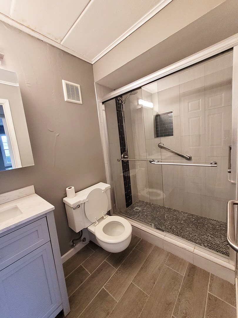 2820 Dundee Road, Unit 2B Northbrook, IL 60062 - Photo 10 of 16 a white toilet sitting next to a bathroom sink and a shower