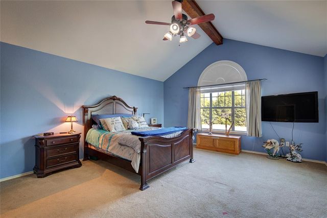 a bedroom with furniture and a flat screen tv