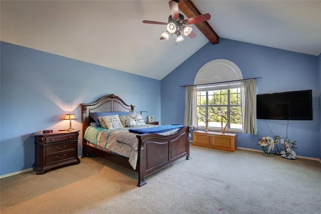 a bedroom with furniture and a flat screen tv