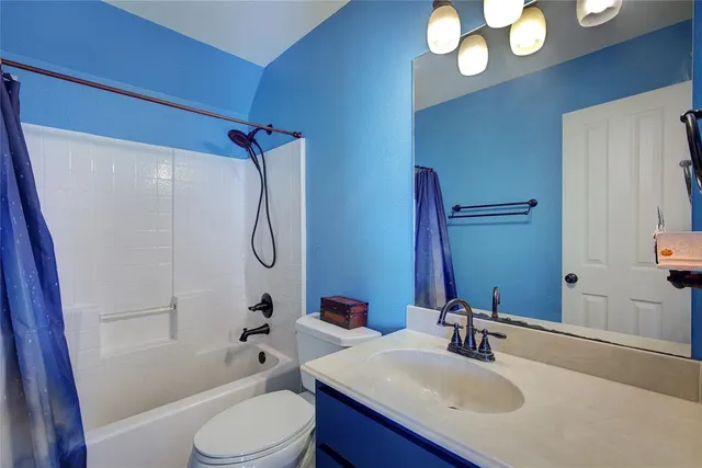a bathroom with a sink vanity granite toilet tub and shower