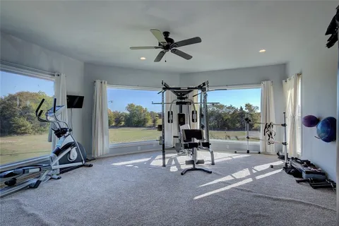 a view of a room with gym equipment and floor to ceiling window