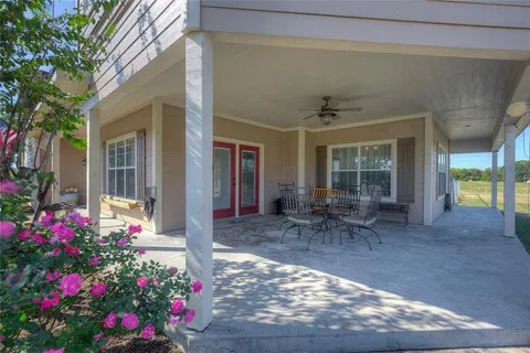 a view of a porch with a table and chairs