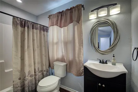 a bathroom with a sink a mirror a toilet and a mirror