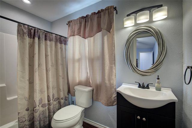 a bathroom with a sink a mirror a toilet and a mirror