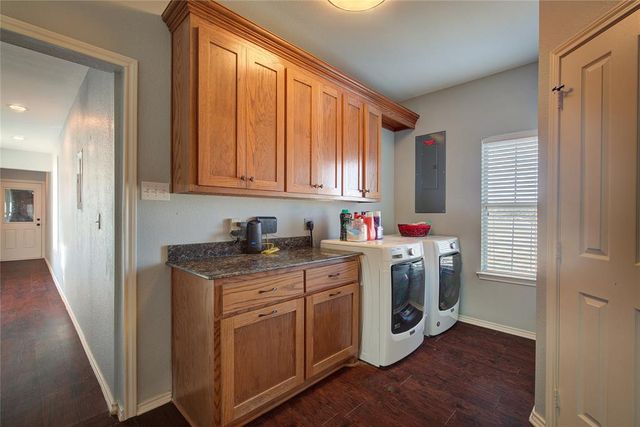 a utility room with cabinets dryer and washer