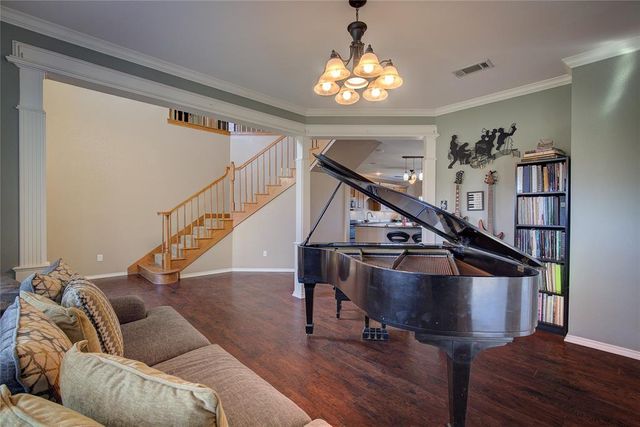 a living room with furniture and stairs