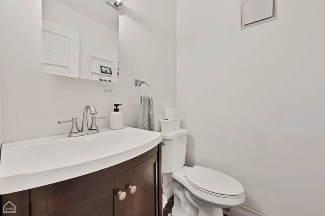 a bathroom with a sink a toilet and a mirror