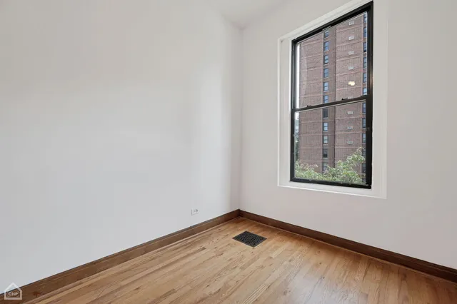 a kitchen with stainless steel appliances kitchen island granite countertop a stove and a refrigerator