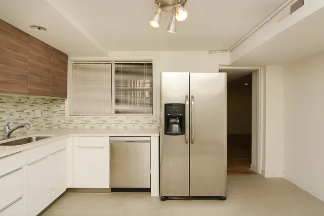 a view of empty room with wooden floor and fireplace