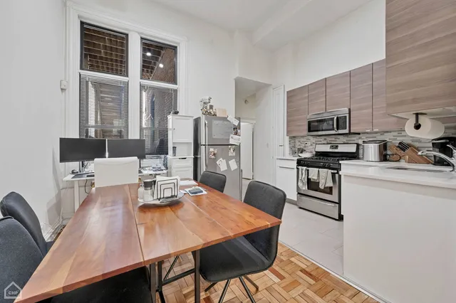 a kitchen with stainless steel appliances a stove sink microwave and cabinets