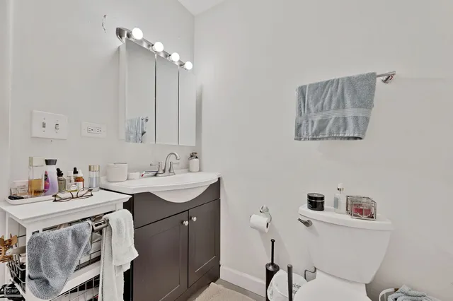 a bathroom with a toilet and a shower curtain