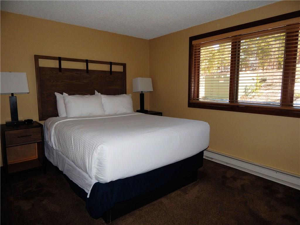 53 View Lane Road, Unit 4D Breckenridge, CO 80424 - Photo 14 of 23 a bed sitting in a bedroom next to a window