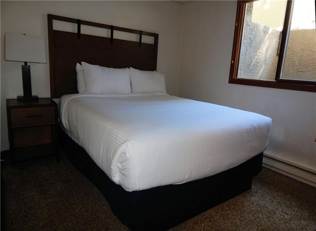 53 View Lane Road, Unit 4D Breckenridge, CO 80424 - Photo 17 of 23 a bed sitting in a bedroom next to a lamp