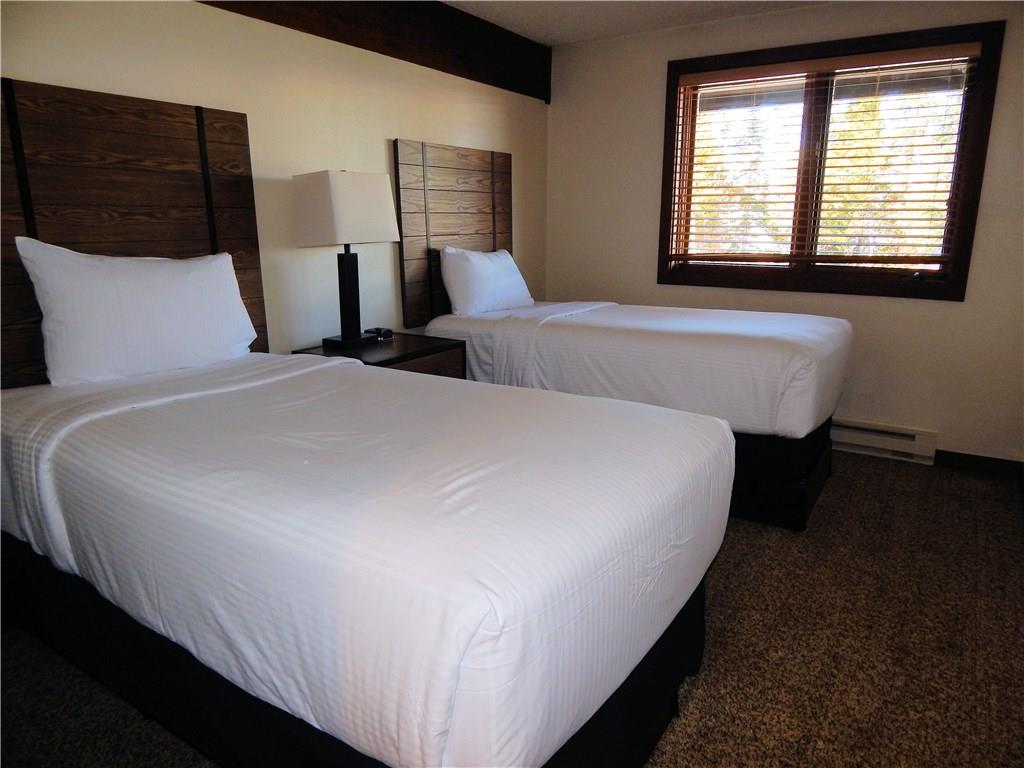 53 View Lane Road, Unit 4D Breckenridge, CO 80424 - Photo 20 of 23 a bed sitting in a bedroom next to a window