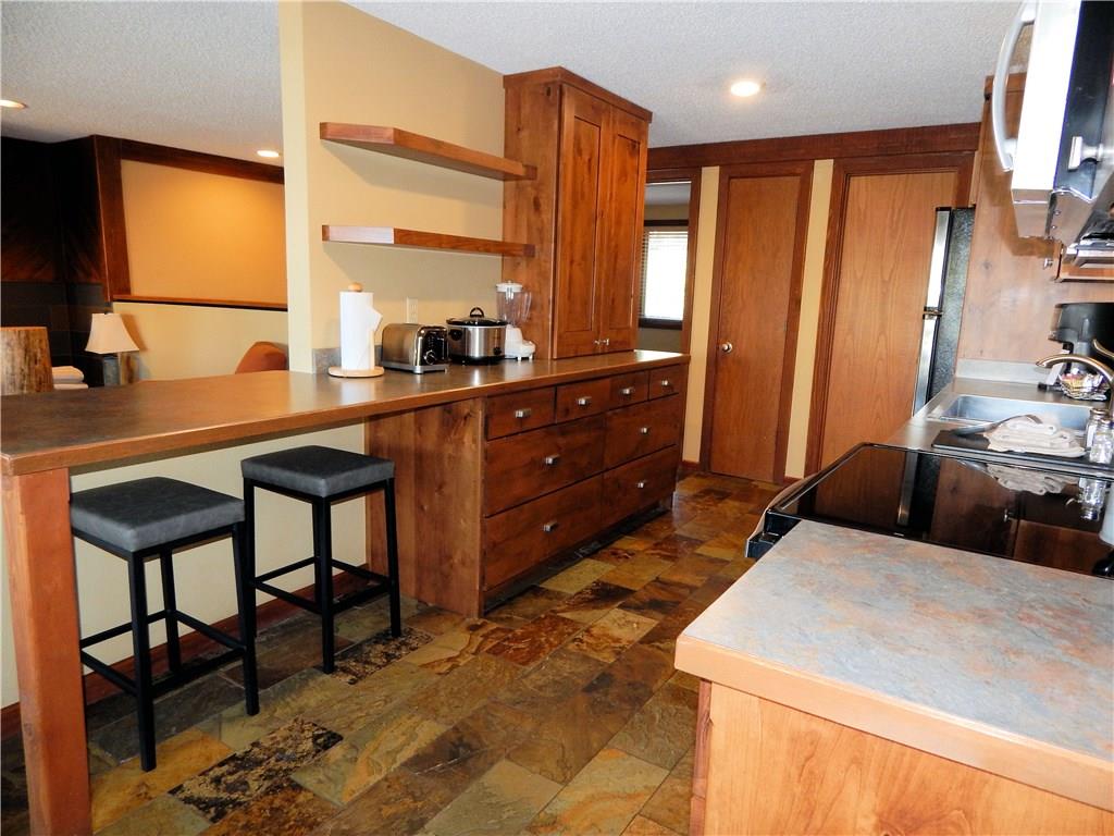 53 View Lane Road, Unit 4D Breckenridge, CO 80424 - Photo 6 of 23 a bedroom with a bed a table and chair