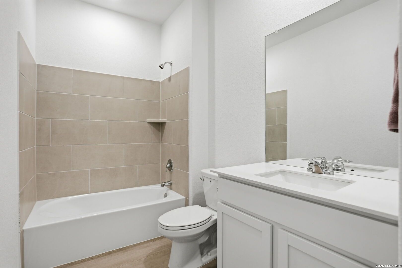 1712 Pahmeyer Path New Braunfels, TX 78130 - Photo 14 of 18 a bathroom with a sink a toilet a mirror and bathtub