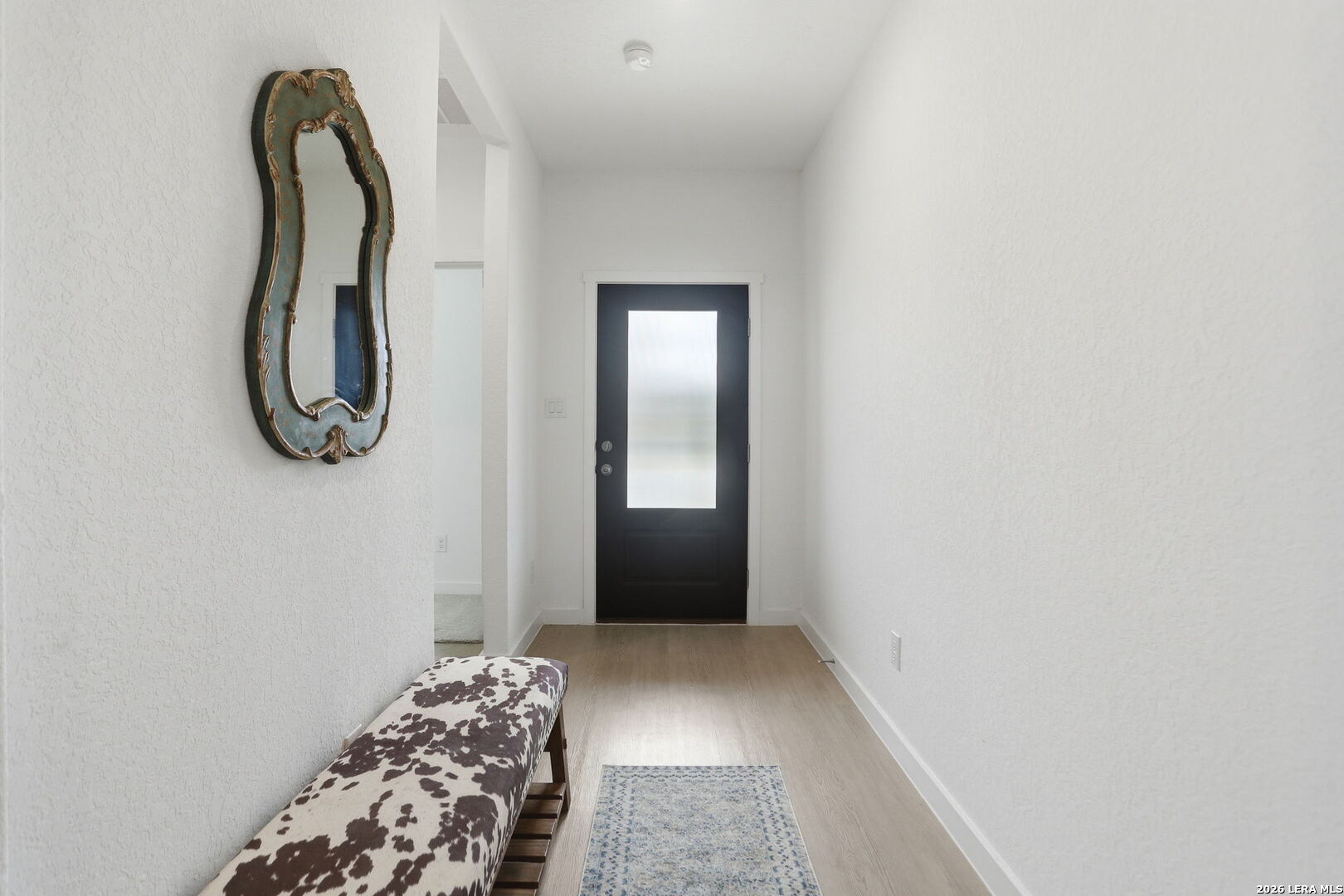 1712 Pahmeyer Path New Braunfels, TX 78130 - Photo 2 of 18 a bedroom with a bed and a mirror