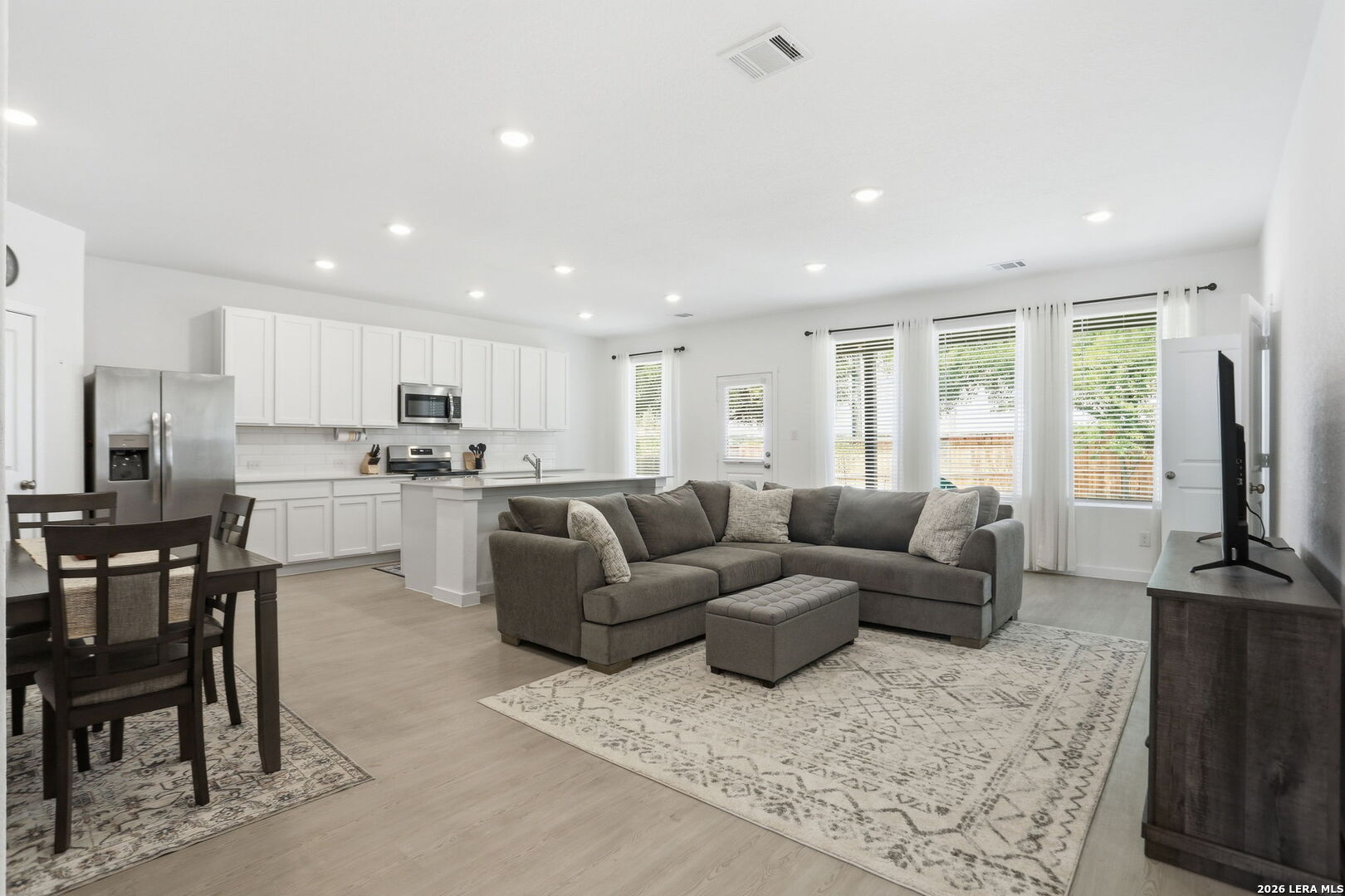 1712 Pahmeyer Path New Braunfels, TX 78130 - Photo 5 of 18 a living room kitchen with furniture and a flat screen tv
