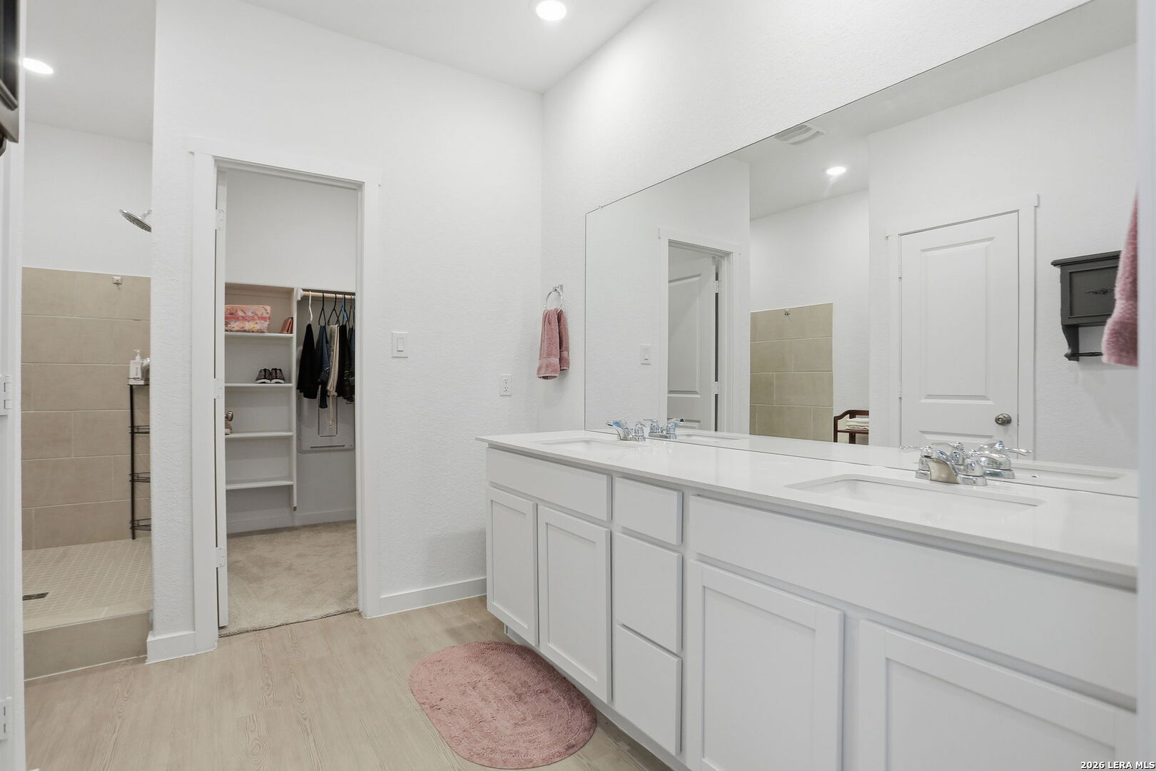 1712 Pahmeyer Path New Braunfels, TX 78130 - Photo 10 of 18 a spacious bathroom with a double vanity sink and mirror