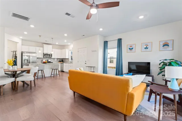 a large white kitchen with lots of counter space a sink appliances and a window