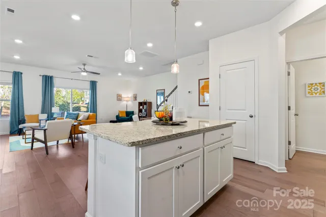 a kitchen with a refrigerator and white cabinets