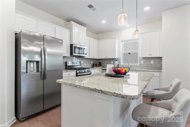 a view of a dining room with furniture and a potted plant