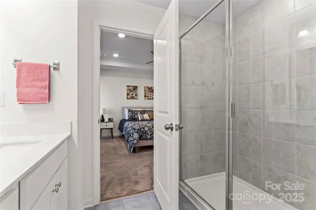 a bathroom with a tub sink and mirror