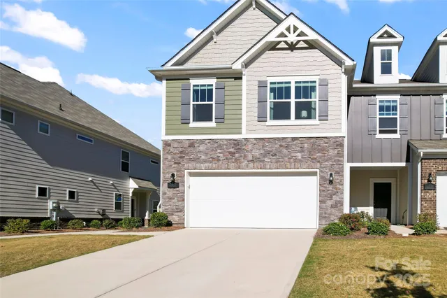 a view of a white house with large windows
