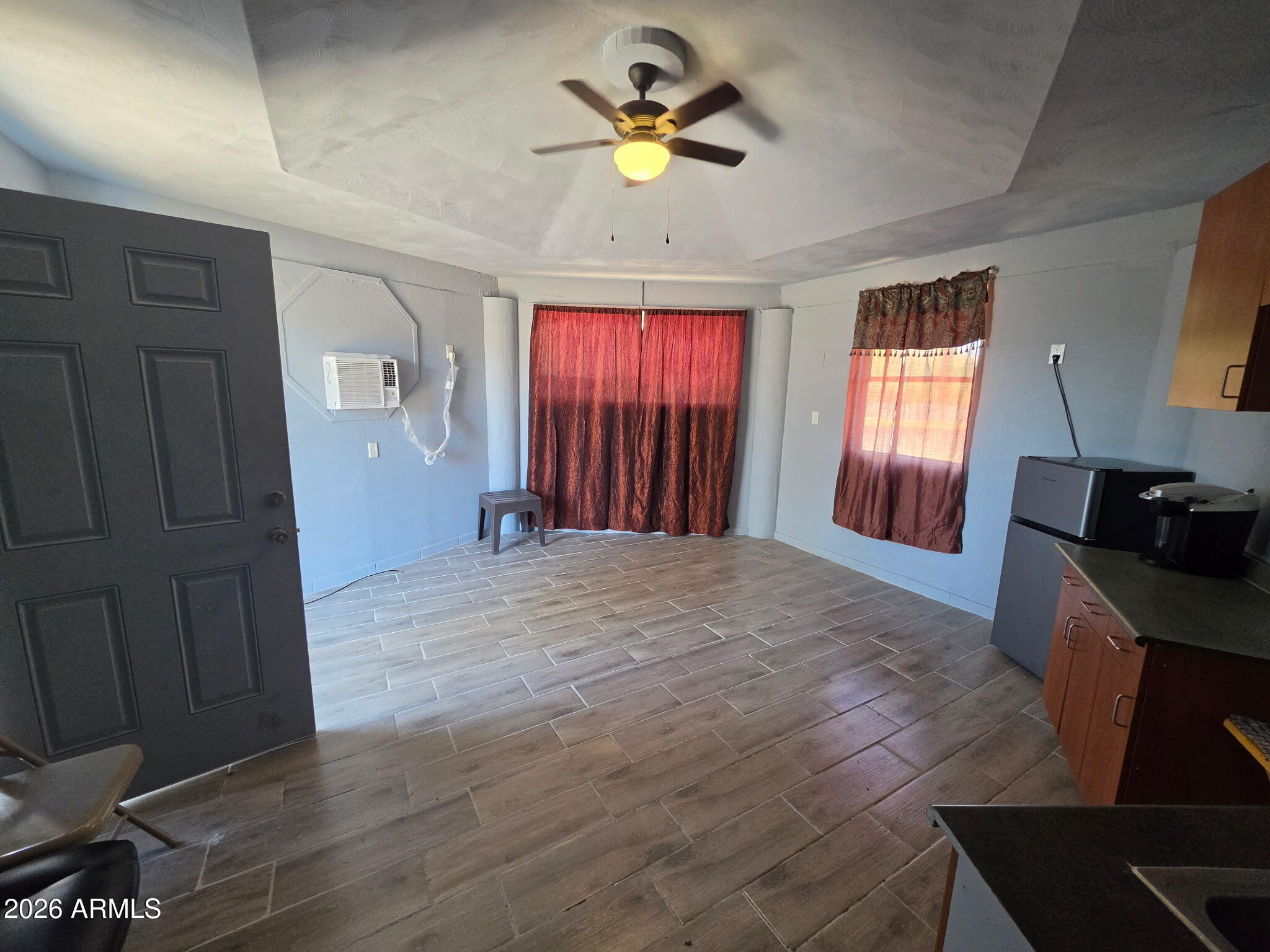 4333 West Carver Road, Unit B Laveen, AZ 85339 - Photo 2 of 6 a view of livingroom with hardwood floor and a ceiling fan