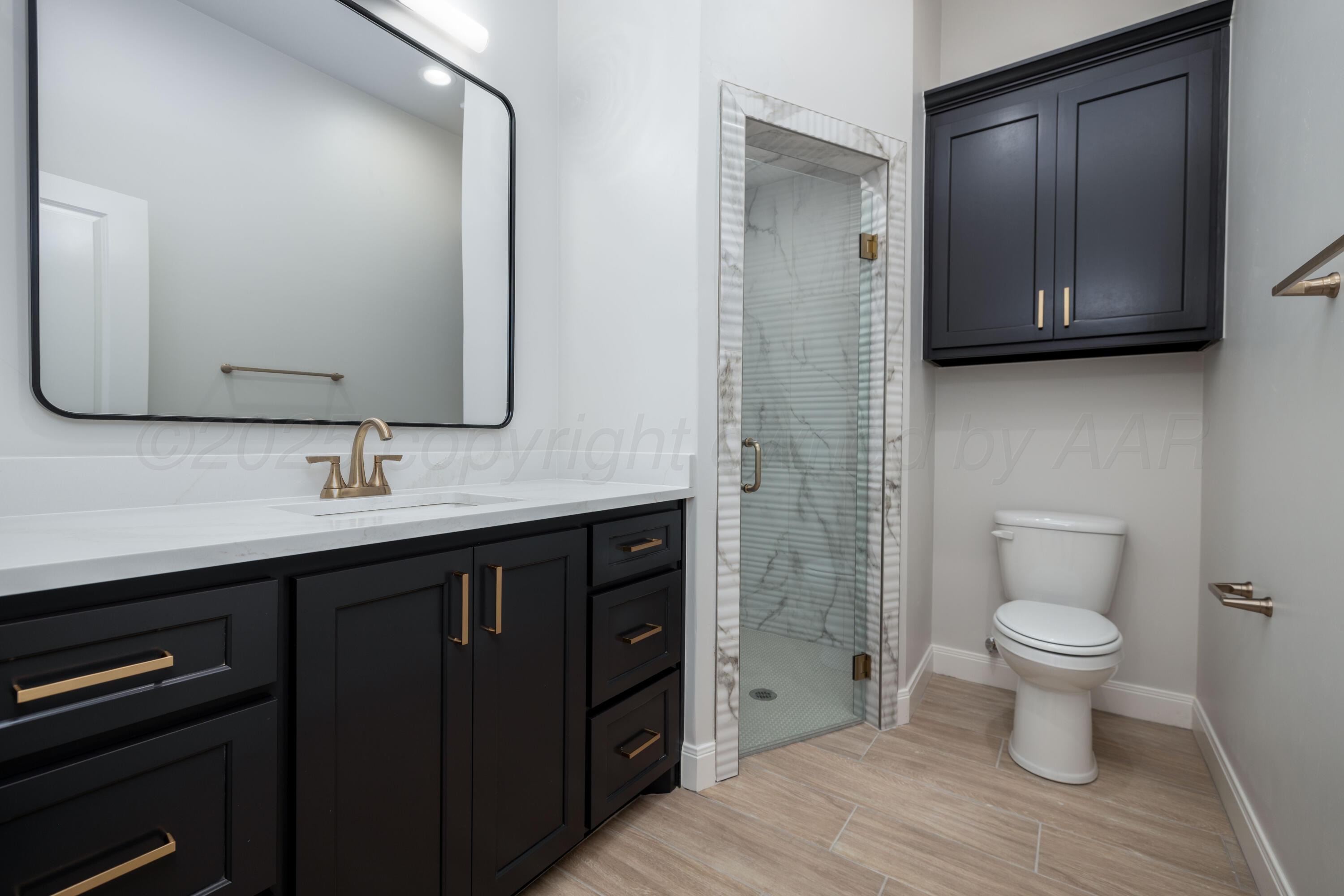10250 Prickly Pear Road Amarillo, TX 79119 - Photo 22 of 41 a bathroom with a toilet sink and mirror