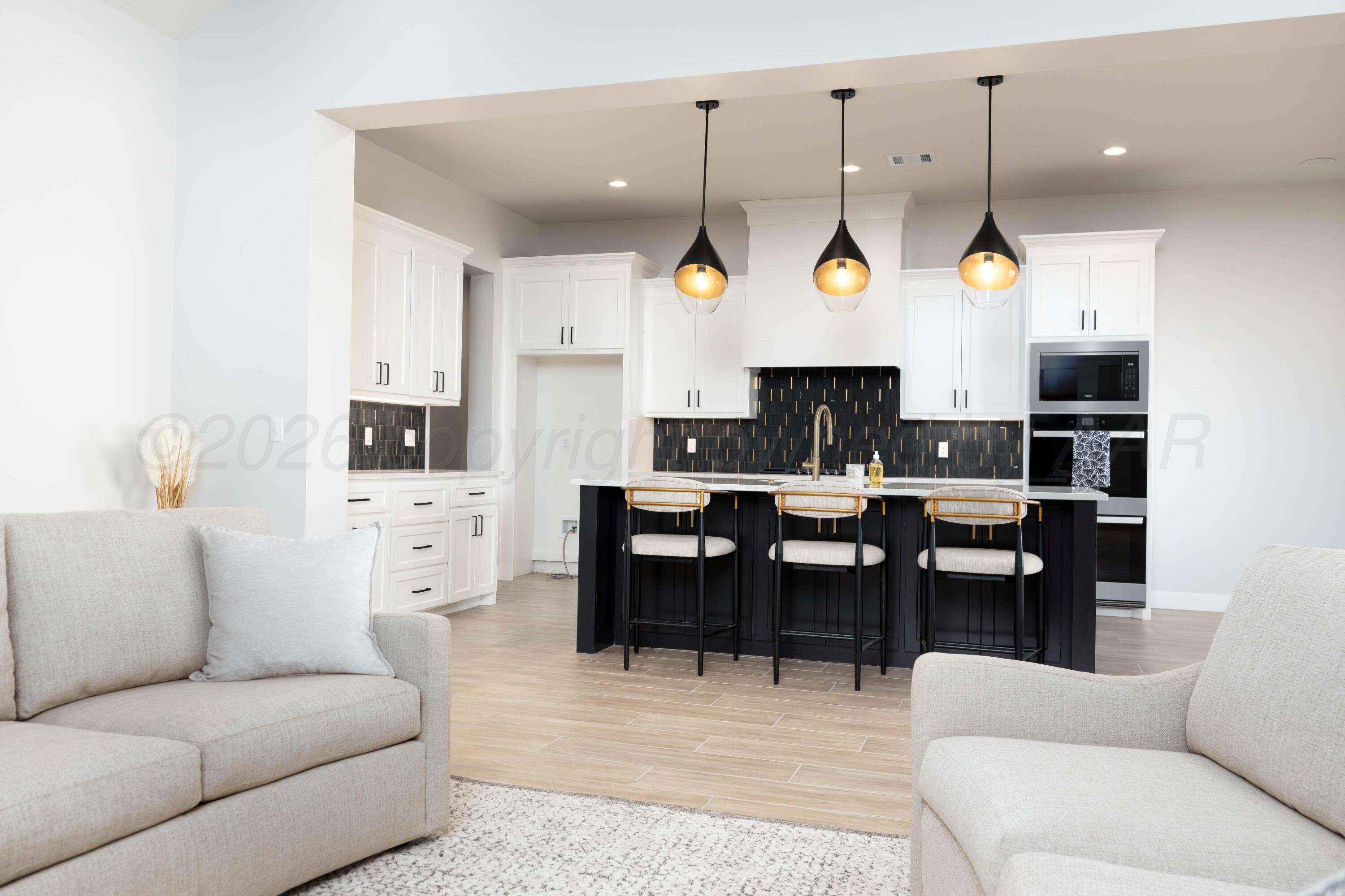 10250 Prickly Pear Road Amarillo, TX 79119 - Photo 7 of 41 a living room with furniture a table and kitchen view
