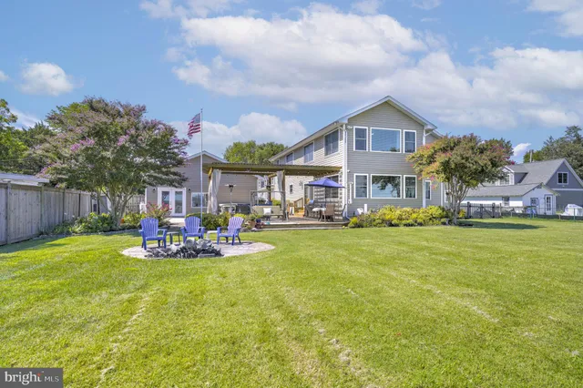 a view of a house with a yard patio and sitting area