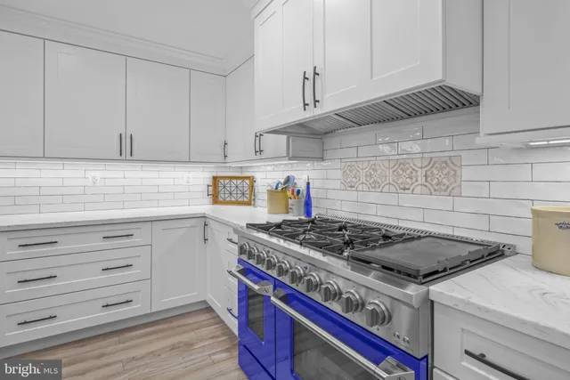 a kitchen with stainless steel appliances a sink stove and refrigerator