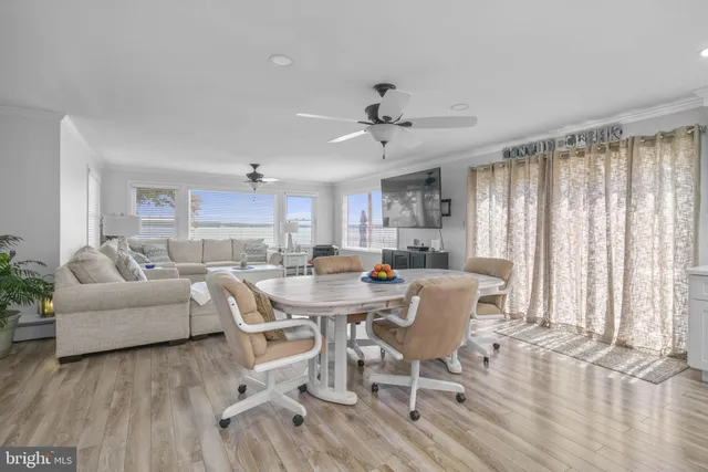 a living room with lots of furniture and view of kitchen