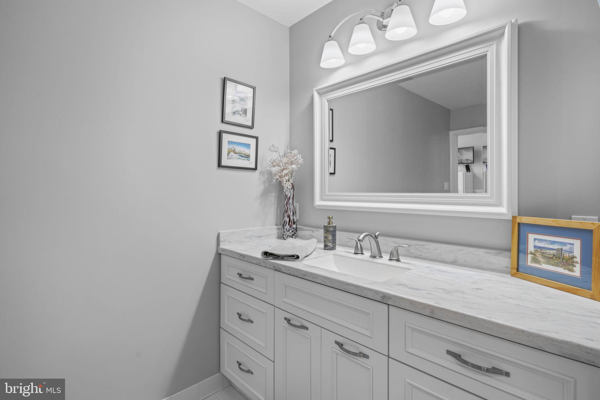 17432 Rock Point Road Newburg, MD 20664 - Photo 21 of 55 a bathroom with a sink vanity and mirror