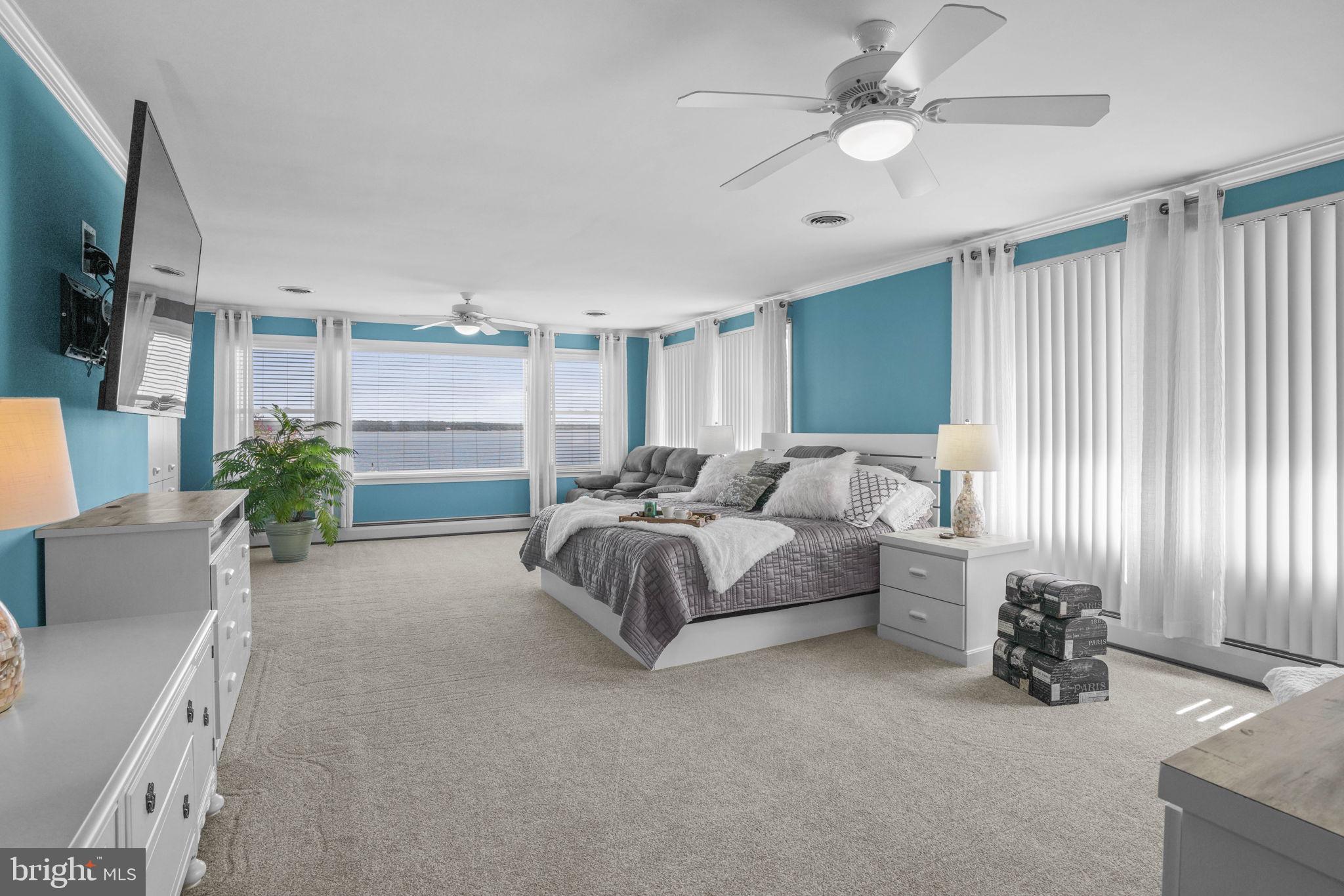 17432 Rock Point Road Newburg, MD 20664 - Photo 25 of 55 a living room with furniture a flat screen tv and a large window