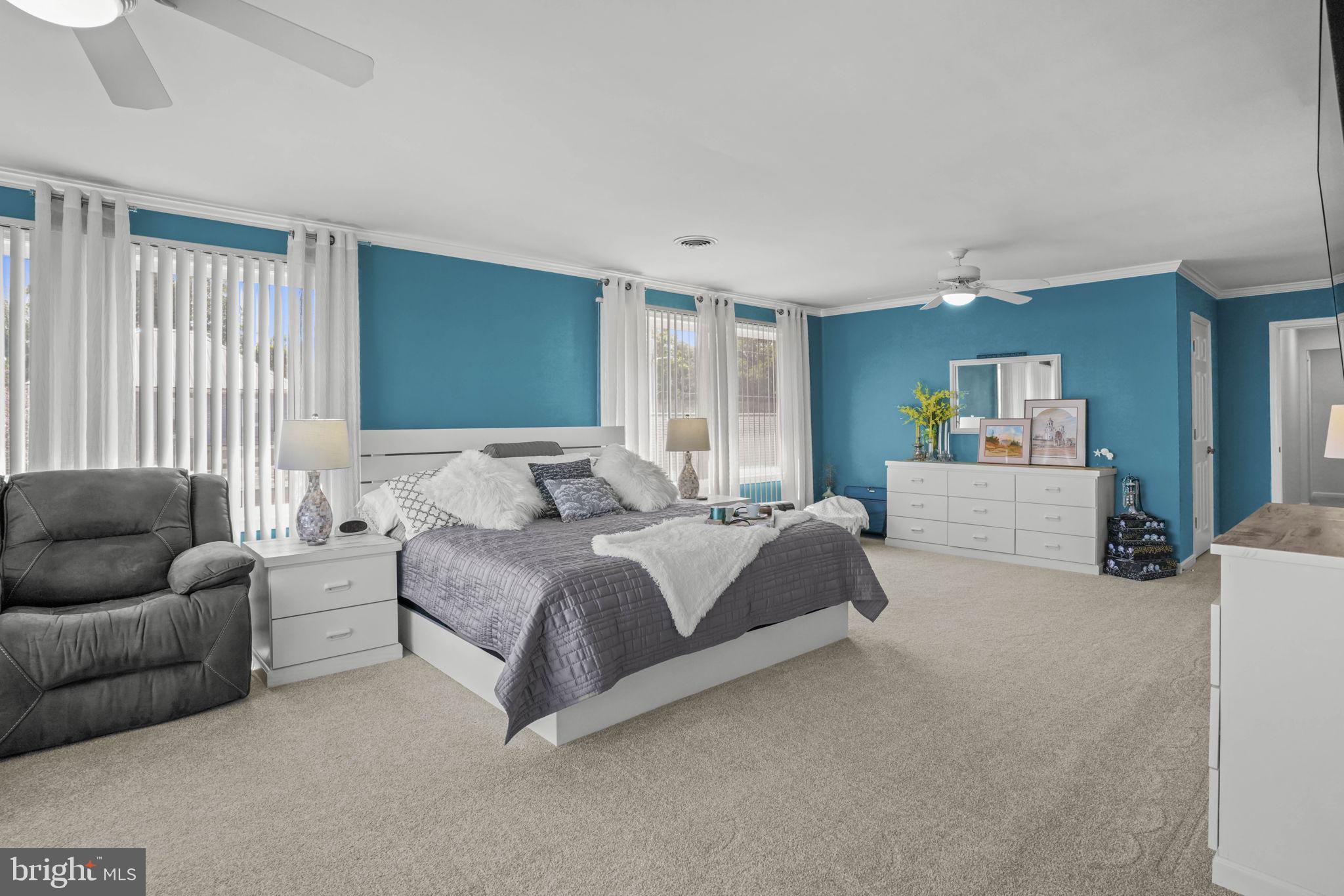 17432 Rock Point Road Newburg, MD 20664 - Photo 28 of 55 a spacious bedroom with a bed and a couch